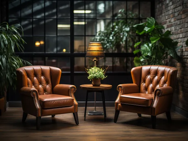 Two chairs in a room with greenery